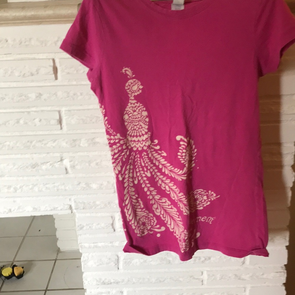 This is a pink shirt with tan design.
